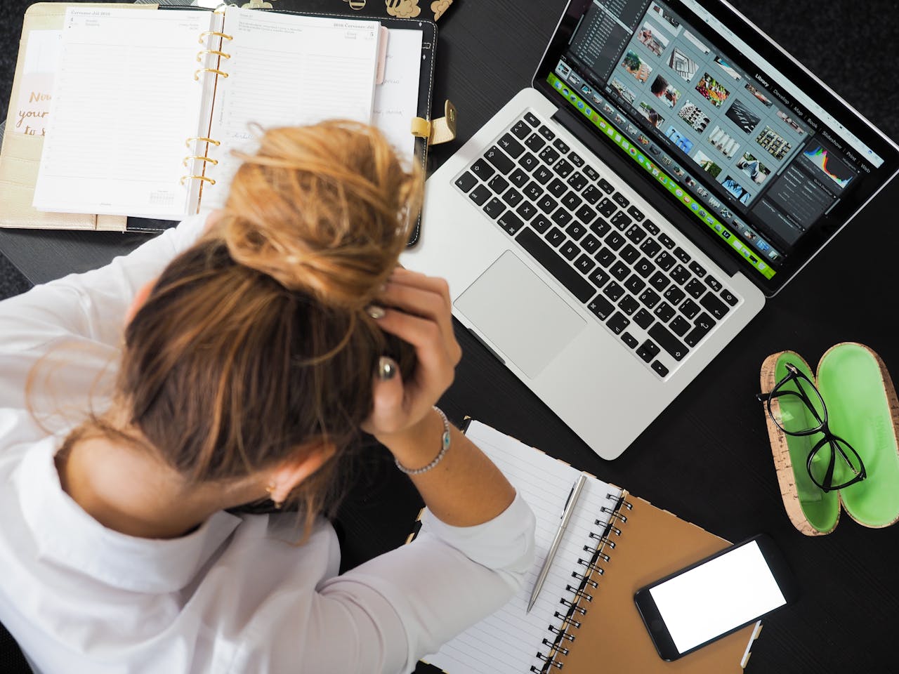 lady at desk with head in hands